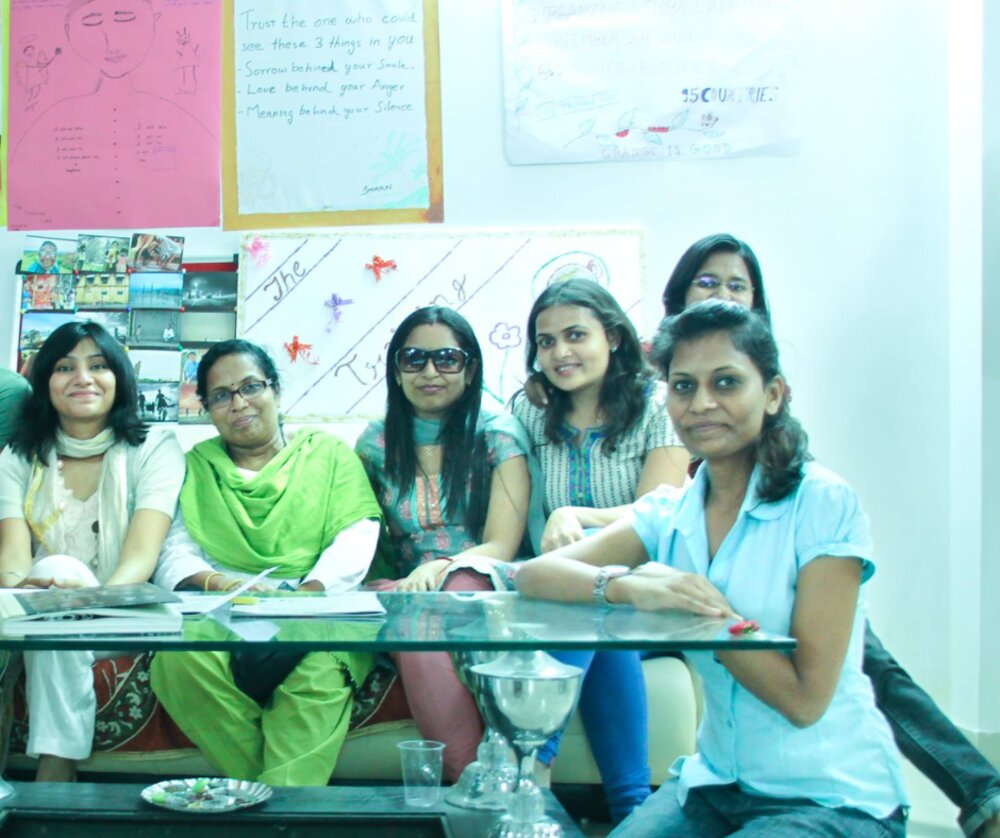 A group of women sitting together, warm and candid